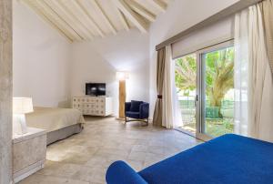 a bedroom with a bed and a sliding glass door at Corte Bianca - Adults Only & SPA - Bovis Hotels in Cardedu +201 photos