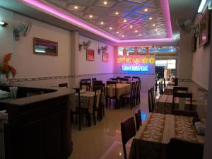 a dining room with tables and chairs in a restaurant at Huynh Lac Can Tho Hotel in Can Tho