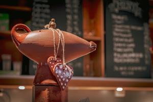 a statue of a teapot with a heart on it at GamlaVaerket Hotel in Sandnes