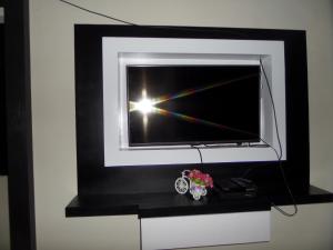 a tv with a black and white frame and a window at Rumah Singgah BRM in Bromo