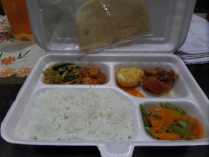 a styrofoam container with rice and vegetables and food at Rumah Singgah BRM in Bromo