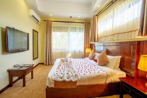 Tempat tidur dalam kamar di Nyaika Hotel