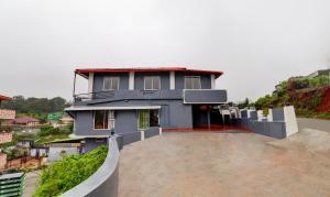 a house on top of a hill with at Treebo Trend New Redfern - Madikeri in Madikeri