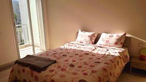 a bedroom with a bed with pillows and a window at F3 Casabay beach sidi rahal vue sur piscine in Sidi Rahal