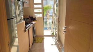 a hallway with a door leading to a kitchen with a stove at F3 Casabay beach sidi rahal vue sur piscine in Sidi Rahal