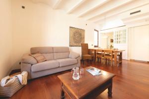a living room with a couch and a table at Bravissimo Mercaders 6 in Girona +25 photos