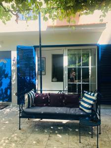 a bench sitting in front of a building at APARTMENT AMBLI HOUSE in Tivat