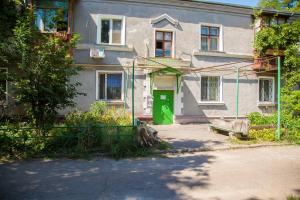 a house with a green door in front of it at 2 Rooms Luxury Apartment on Divnogorskaya 13 Street in Zaporozhye