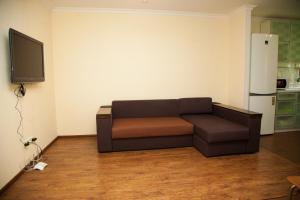 a living room with a couch and a tv at 2 Rooms Luxury Apartment on Divnogorskaya 13 Street in Zaporozhye