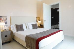 Postel nebo postele na pokoji v ubytování L' Araba Fenice Hotel & Resort