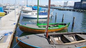 a group of boats docked at a dock at Struer Town Apartment in Struer