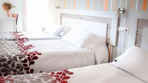 Postel nebo postele na pokoji v ubytování Hotel Albero
