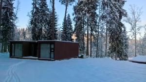 a small cabin in the woods in the snow at Kempings Ozolkalns in Cēsis