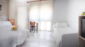 Postel nebo postele na pokoji v ubytování Hotel Albero
