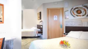 Postel nebo postele na pokoji v ubytování Hotel Albero