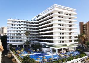 a large white building with a pool in front of it at BLUESEA Gran Cervantes in Torremolinos