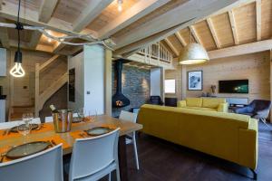 - une salle à manger et un salon avec un canapé jaune dans l'établissement Superbe chalet-11 personnes-Chamonix(Les Bossons), à Chamonix-Mont-Blanc