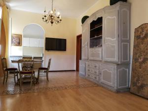 a large white hutch in a dining room with a table at bellaria in Voghera