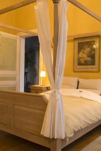 a bedroom with a canopy bed with white curtains at Atlas B&B in Ghent +26 photos