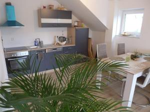 a kitchen with a table and a kitchen with a plant at Ferienwohnung Deifel in Schömberg