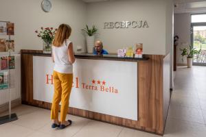 a woman standing at a counter in a pharmacy at Terra Bella in Biała Podlaska