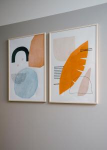 two pieces of art hanging on a wall at TJB Design Apartment RAJSKA 8 in Gdańsk