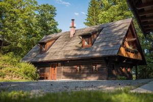 een blokhut met een gambrel dak bij Počitniška hiša Koča Dobnik in Lovrenc na Pohorju