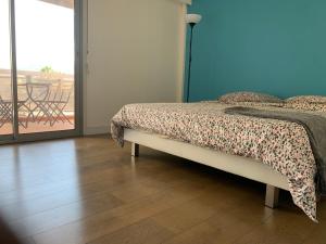 a bedroom with a bed and a wooden floor at PRADO PLAGE in Marseille