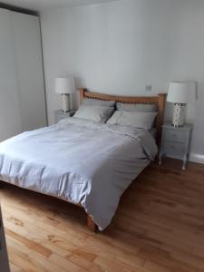 a bedroom with a large bed with two night stands at Luxurious Penthouse Apartment 1 , City Centre in Kilkenny