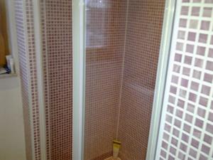 a shower with a glass door next to a toilet at Awesome Panorama Penthouse - free Parking and balcony in Sarajevo +18 photos