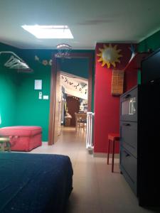 a bedroom with green and red walls and a bed at Terrazze Verdi in Brolo