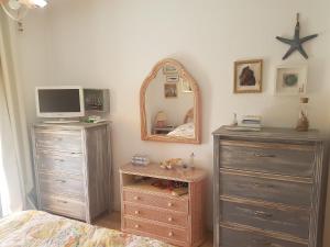 sypialnia z łóżkiem, komodą i lustrem w obiekcie Sunny Beach Apartment Holidays w mieście Vila do Conde