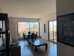 a living room with a table and a couch at PRADO PLAGE in Marseille