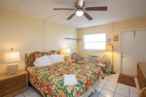 a bedroom with a bed and a ceiling fan at Venice Villas * Studio #49 in Venice
