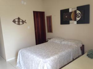 En eller flere senge i et værelse på Pousada Sua Casa