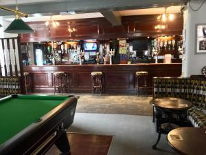 a pub with a pool table and a bar at The Rathmore in Cambridge