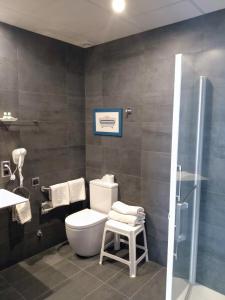 a bathroom with a toilet and a sink and a shower at Hotel Marblau Tossa in Tossa de Mar