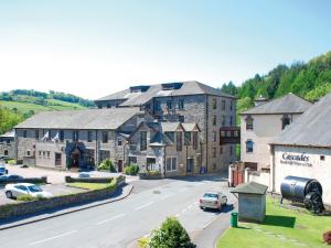 an aerial view of a small town with cars parked on the street at Whitewater Hotel & Spa in Newby Bridge