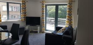 sala de estar con sofá y TV en Horseshoe Apartments en Portsmouth