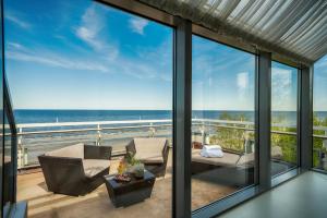 a living room with a view of the ocean at Baltic Beach Hotel & SPA in Jūrmala