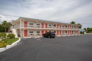 a large building with a car parked in a parking lot at Venice Villas * Studio #53 in Venice