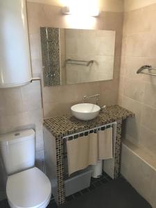 a bathroom with a sink and a toilet at beau meublé centre historique in Bordeaux