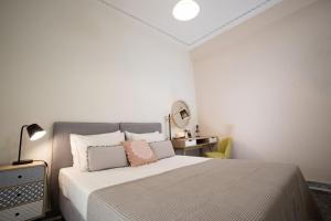 - une chambre avec un grand lit et un miroir dans l'établissement Hellona house ,sunny and cozy apartment's, à Nauplie