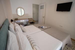 - une chambre avec 2 lits et une télévision dans l'établissement Hellona house ,sunny and cozy apartment's, à Nauplie