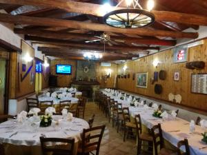 a room with tables and chairs with white tablecloths at B&B Francesca in Zagarise