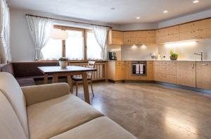 a living room with a couch and a table at Ciasa Roenn in Colfosco