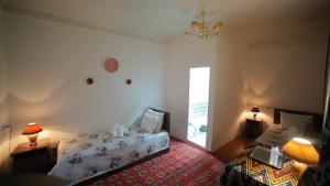 Katil atau katil-katil dalam bilik di Qutlug Qadam Guest House