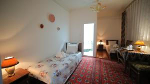 Katil atau katil-katil dalam bilik di Qutlug Qadam Guest House