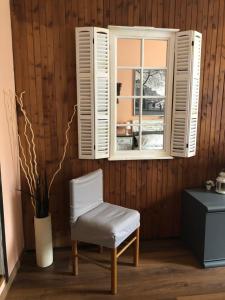 a white chair sitting in front of a window at Sportinghouse in Garessio