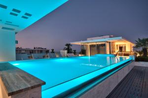 a swimming pool with blue lighting in a house at Hotel Valentina in St. Julianʼs
